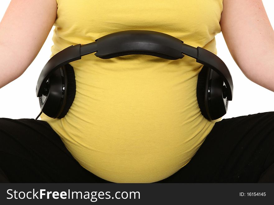 Set of headphones on pregnant belly. Set of headphones on pregnant belly