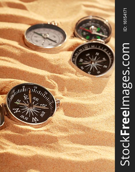 Compasses On Sand