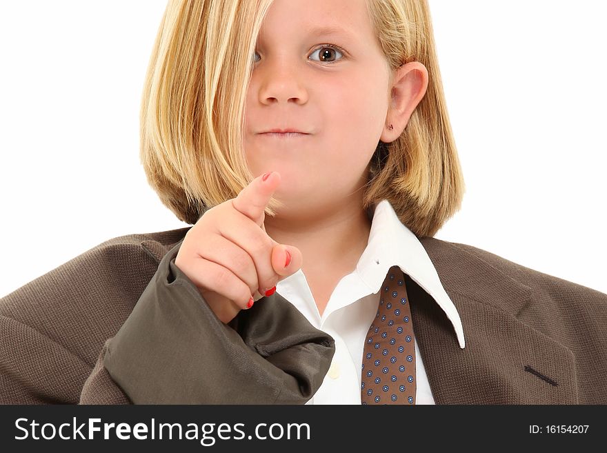 Adorable 7 year old blond american girl in baggy suit pointing angry towards camera over white background. Adorable 7 year old blond american girl in baggy suit pointing angry towards camera over white background.