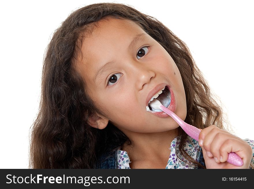 Cute girl cleans teeth, child with toothbrush against white background