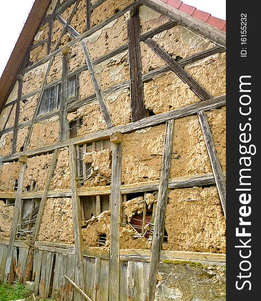 Facade of a half-timbered farmhouse in decay. Franken, Bavaria, Germany. Facade of a half-timbered farmhouse in decay. Franken, Bavaria, Germany