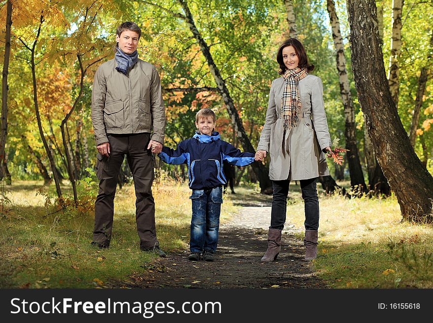 Happy family walking at the autumn park. Happy family walking at the autumn park.