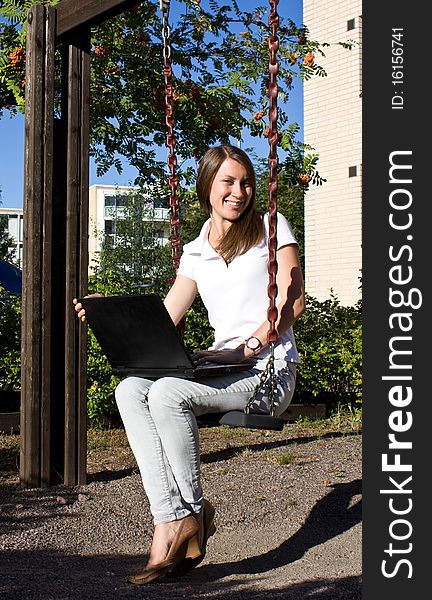 Happy girl on the street with a laptop