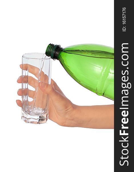 Woman pouring water to a glass from the bottle. Woman pouring water to a glass from the bottle