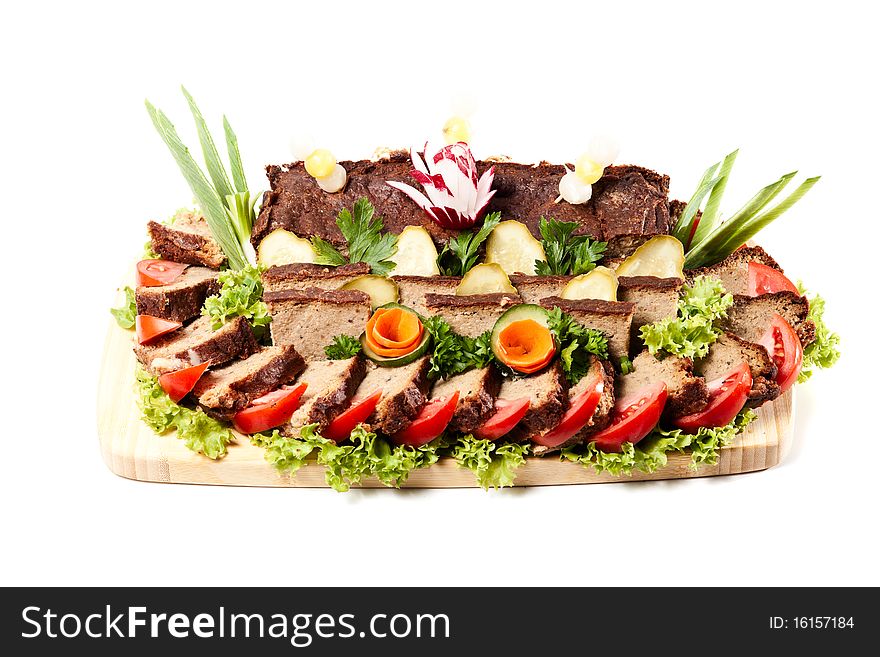 Liver pie decorated vegetables and herbs on white background