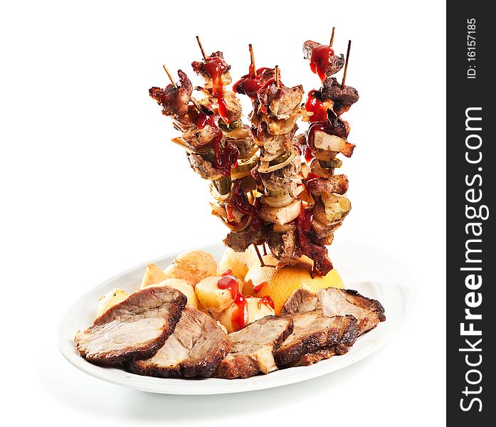 Beef roast and skewers with potato for dinner on white background. Beef roast and skewers with potato for dinner on white background