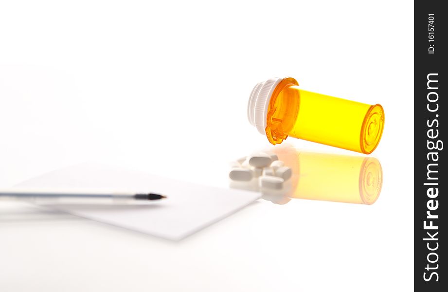 Medicine bottle, tipped over, pile of pills prescription and pen on a white background. Medicine bottle, tipped over, pile of pills prescription and pen on a white background.