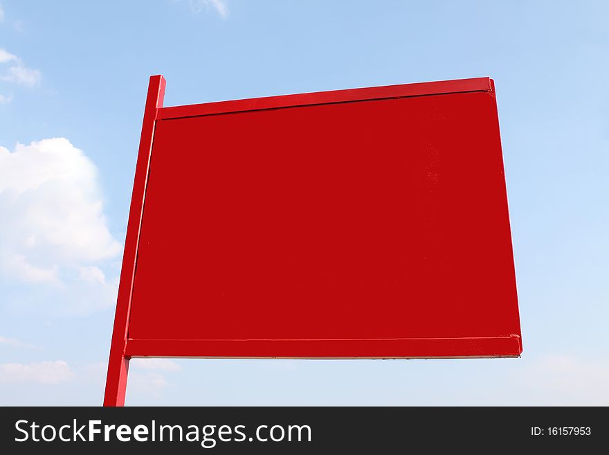 A bright red sign against a blue sky. Put in your own message.