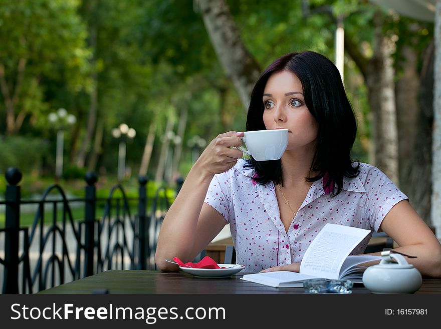 Young beautiful student girl with notepad in the cafe. Young beautiful student girl with notepad in the cafe