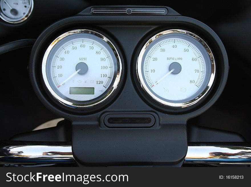 Motorcycle speedometers on chrome and black. Motorcycle speedometers on chrome and black.