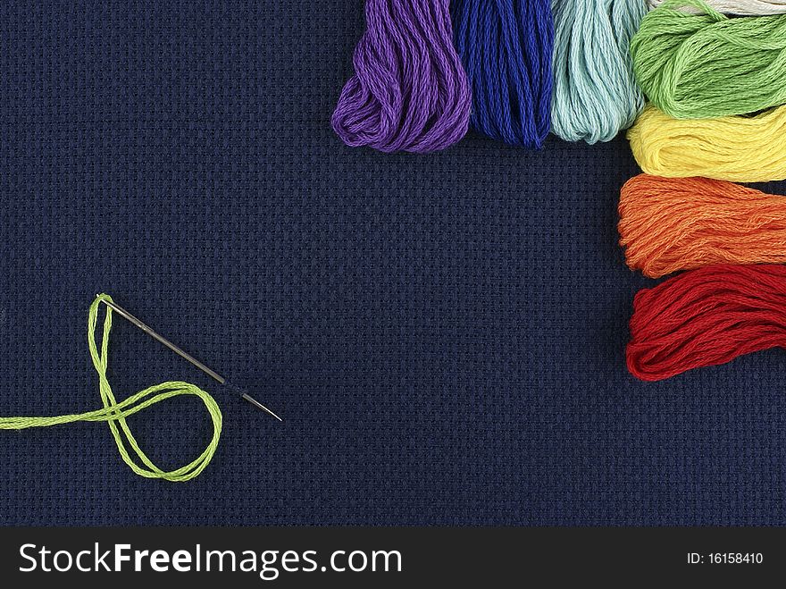 Multi-coloured threads on a dark blue background. Multi-coloured threads on a dark blue background