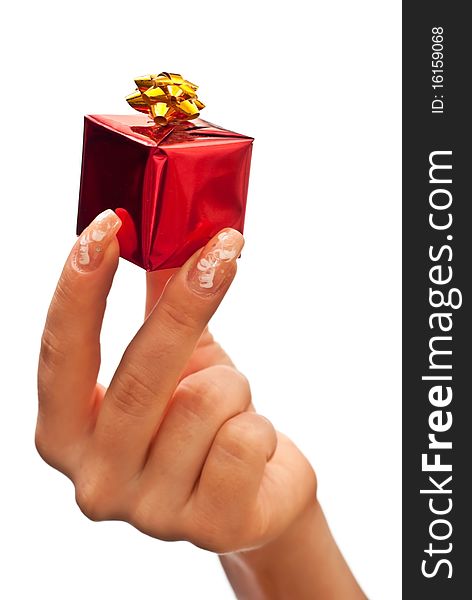 Woman's hand with a small red gift box with gold bow. White background