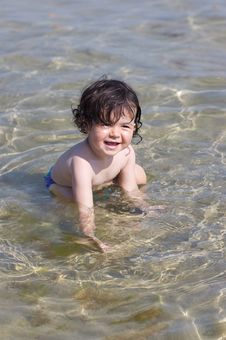 Little Kid Playing In The Sea Royalty Free Stock Photos