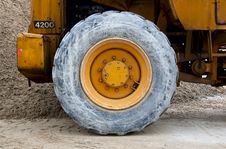 Wheel Of Backhoe Or Tractor Over Sand Royalty Free Stock Images