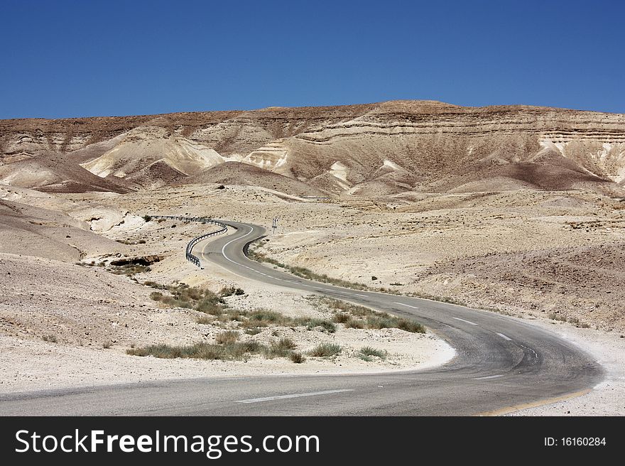 This is an image of a curvy desert road at the mountains near the dead sea Israel.