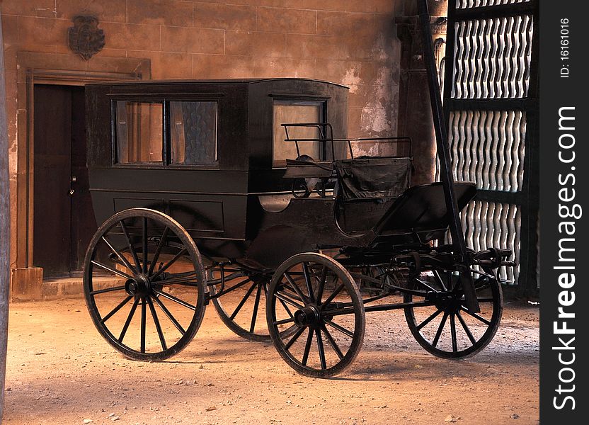 Antique black carriage in the courtyard of a palace in Mallorca