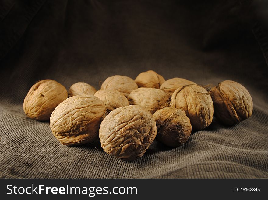 Lots of Brown delicious nuts on the dark backround