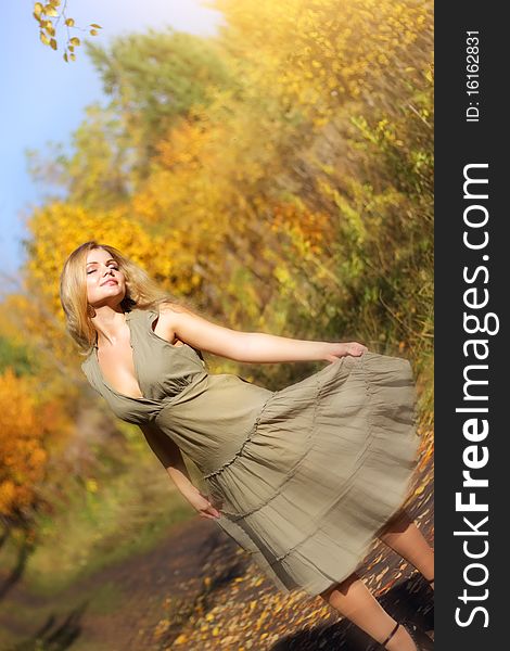Attractive girl dances in the autumn forest