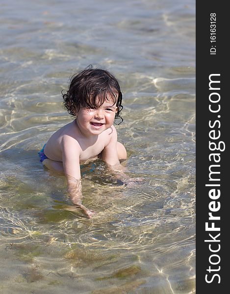 Little kid playing in the sea