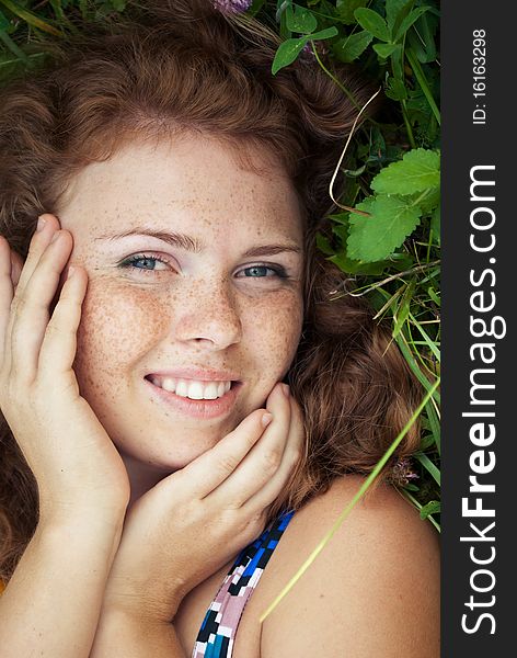 Beautiful Ginger Girl Is Lying In The Green Grass