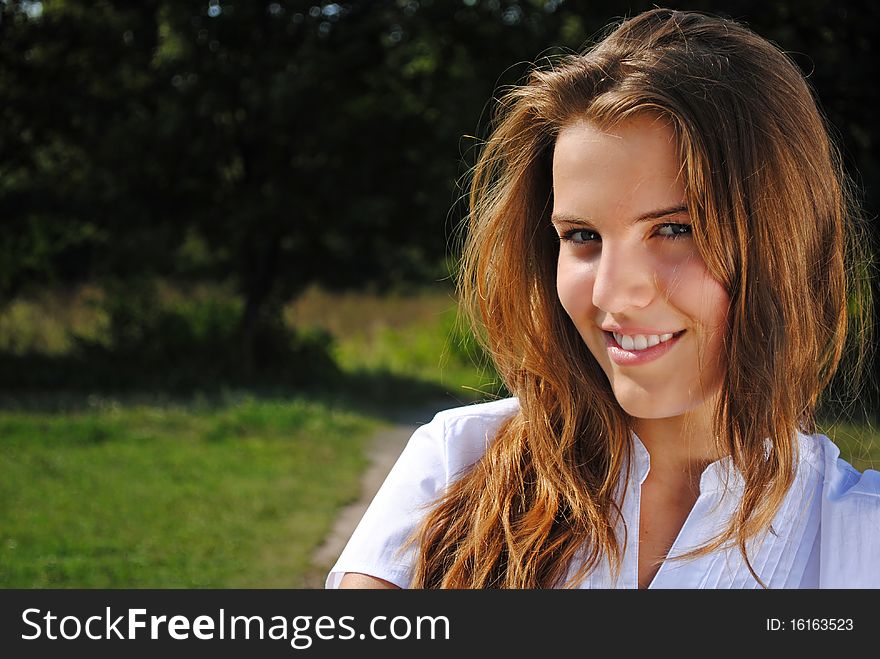 Beautiful student girl is smiling and looking at you