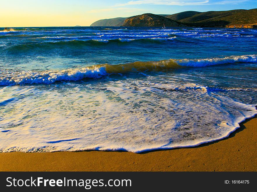 Sand on the Aegean coast and the mountains far away