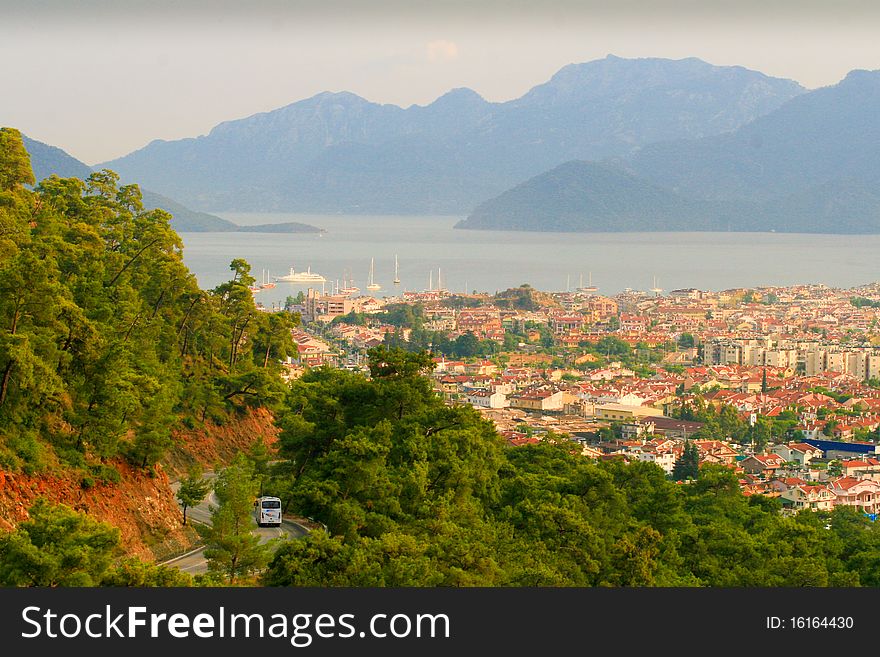 The city Marmaris by the sea and the mountains in the haze. Turkey