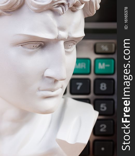 Ancient Roman bust with calculator keys in the background. Ancient Roman bust with calculator keys in the background
