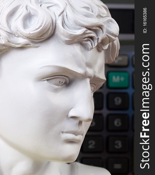 Ancient Roman bust with calculator keys in the background. Ancient Roman bust with calculator keys in the background