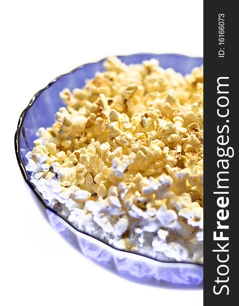 Popcorn in a blue basket. Isolated on a white background.