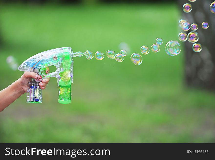 Flying soap bubbles on green background