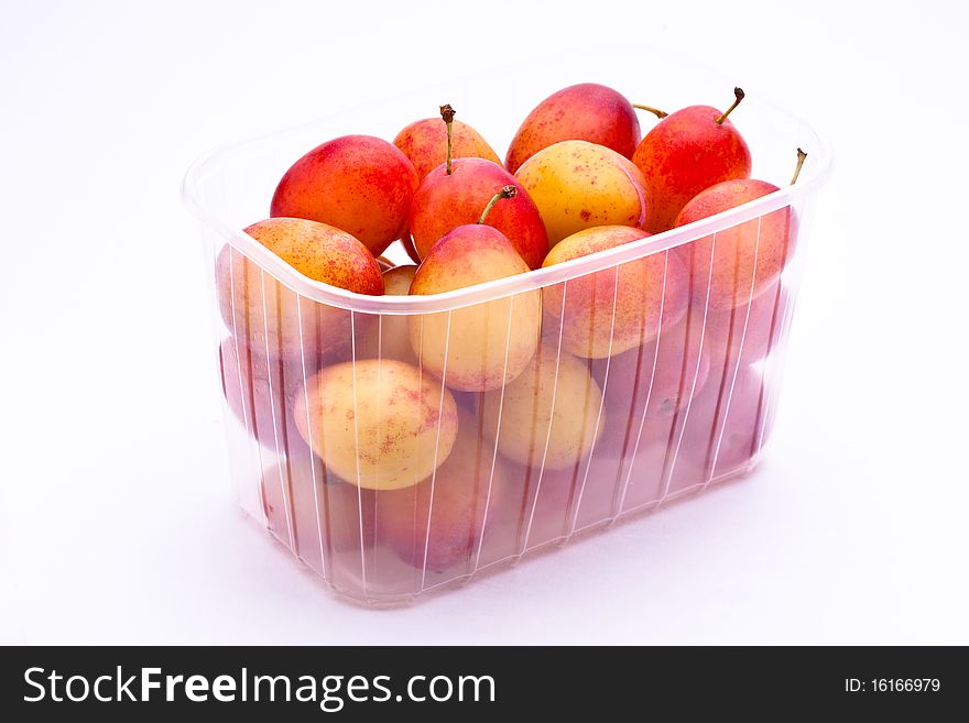 Victoria Plums in a display punnet on a white background