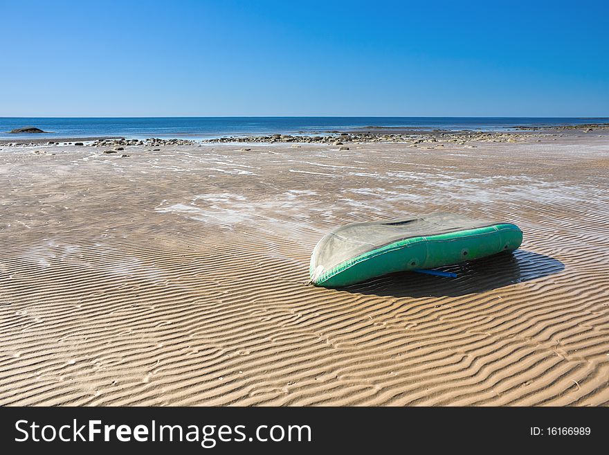 Inverted inflatable boat on the sea tide.