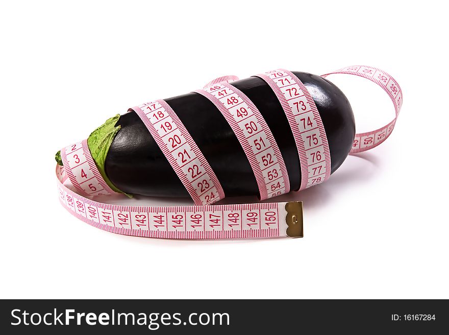 Black eggplant and tape measure photographed on white background.