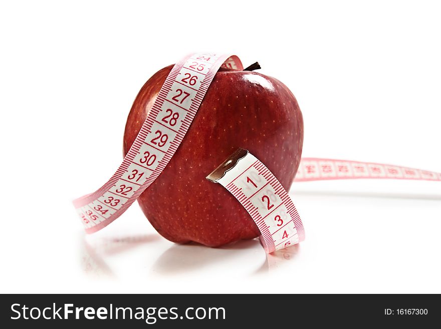 Red Apple isolated on white with measuring tape. Great diet concept.