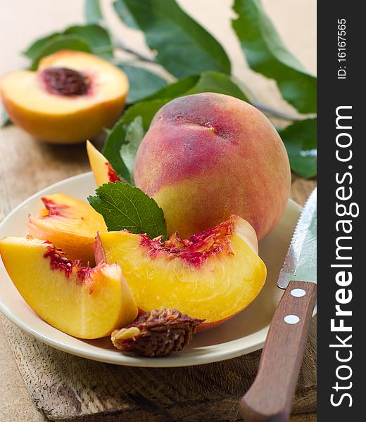 Fresh peaches on plate with knife