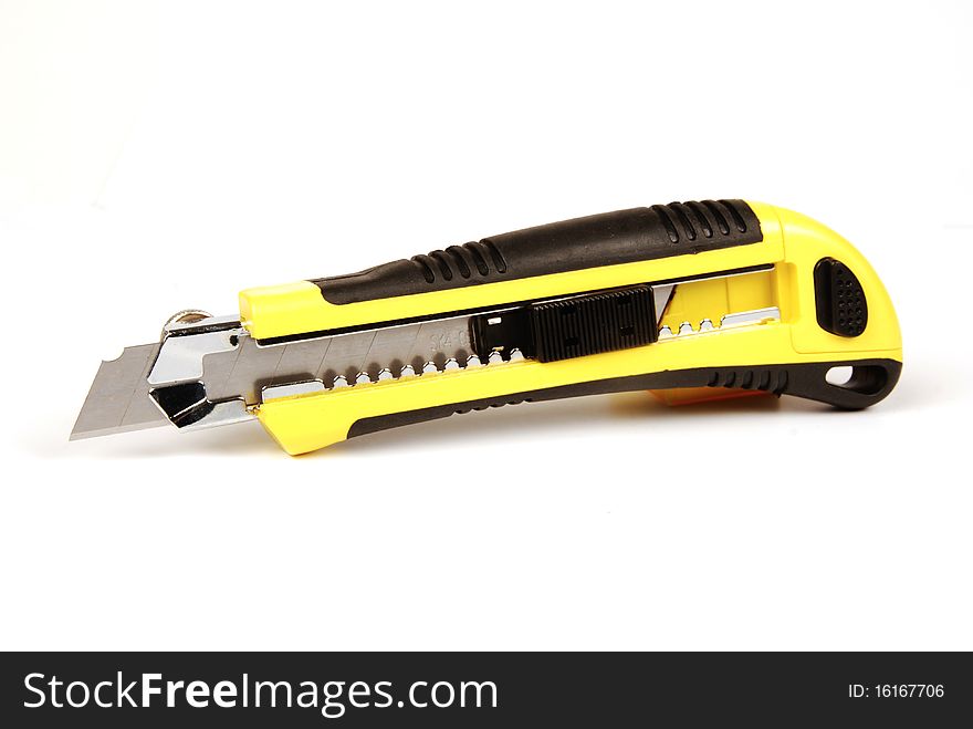 A yellow and black craft knife isolated on a white background