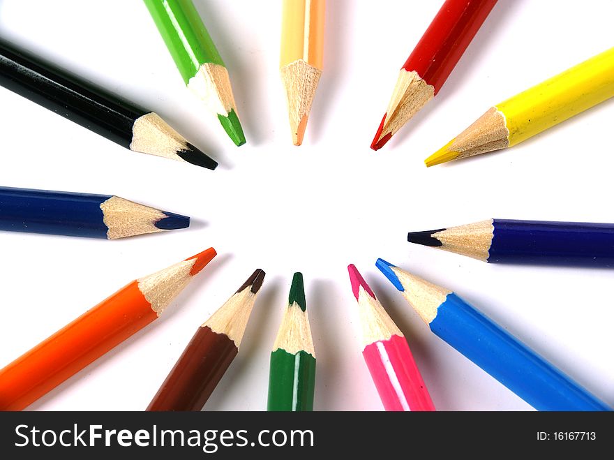 A selection of pencil crayons in a circle on a white background. A selection of pencil crayons in a circle on a white background