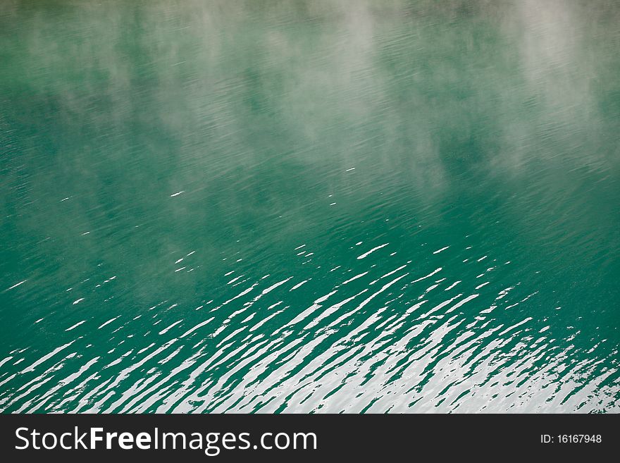 Morning mist rising from alpine lake. Morning mist rising from alpine lake