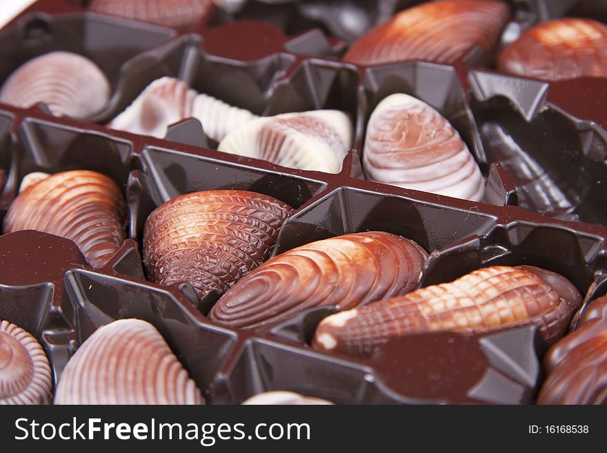 Chocolate sweet-shells lies in the box