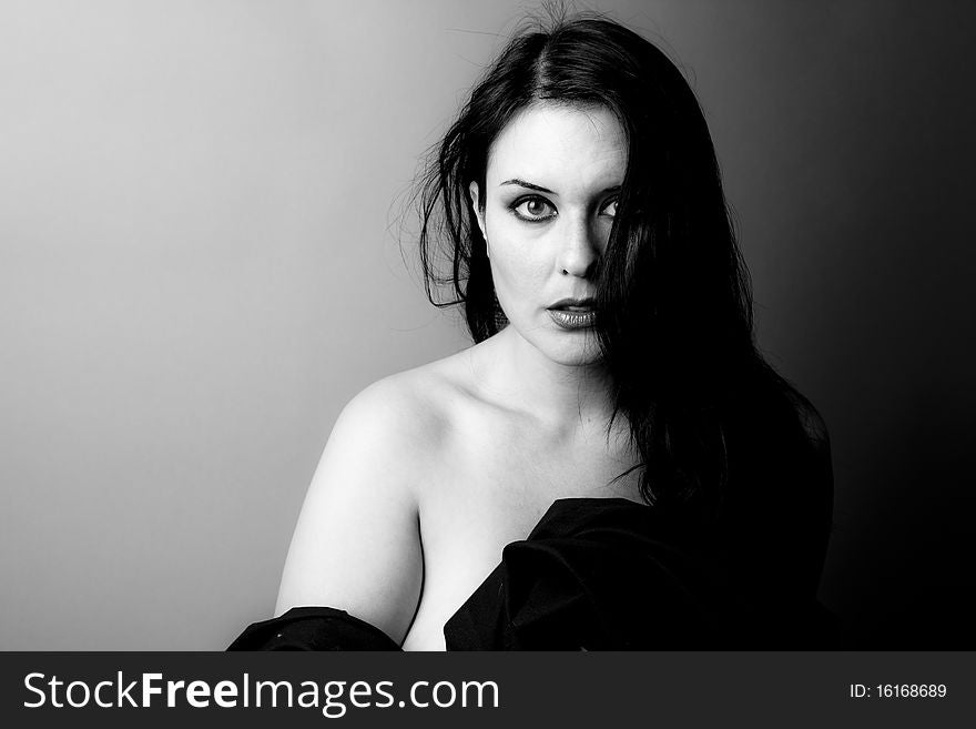 Voluptuous look of brunette young woman. Black and white