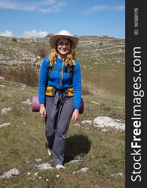 Smiling backpacker girl walking outdoor