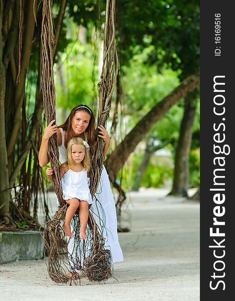 Mother And Her Little Daughter In Tropical Park