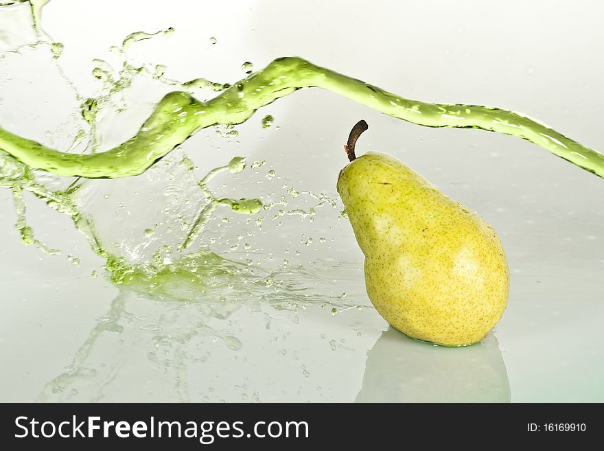 A pear with a splash of water