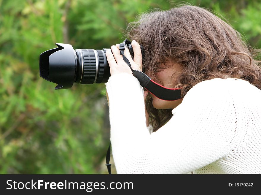 Girl taking picture on natural background. Girl taking picture on natural background