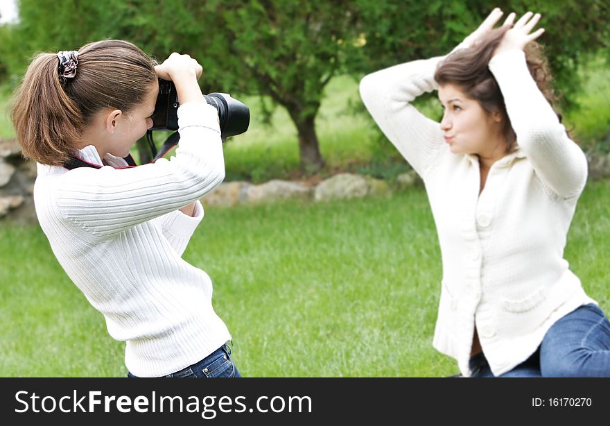 Two girls taking pictures on nature