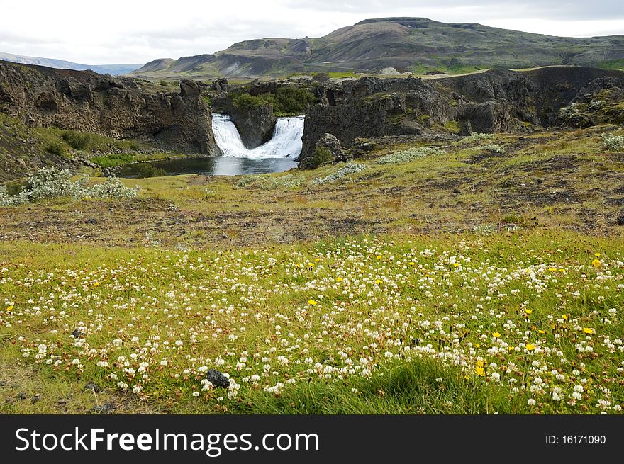 Hjalparfoss cascade is situated in the lava fields north of the volcano Hekla in Iceland. Hjalparfoss cascade is situated in the lava fields north of the volcano Hekla in Iceland.
