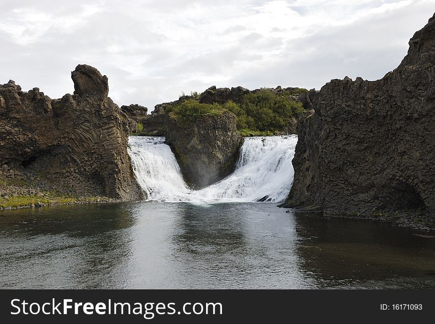 Hjalparfoss cascade is situated in the lava fields north of the volcano Hekla in Iceland. Hjalparfoss cascade is situated in the lava fields north of the volcano Hekla in Iceland.