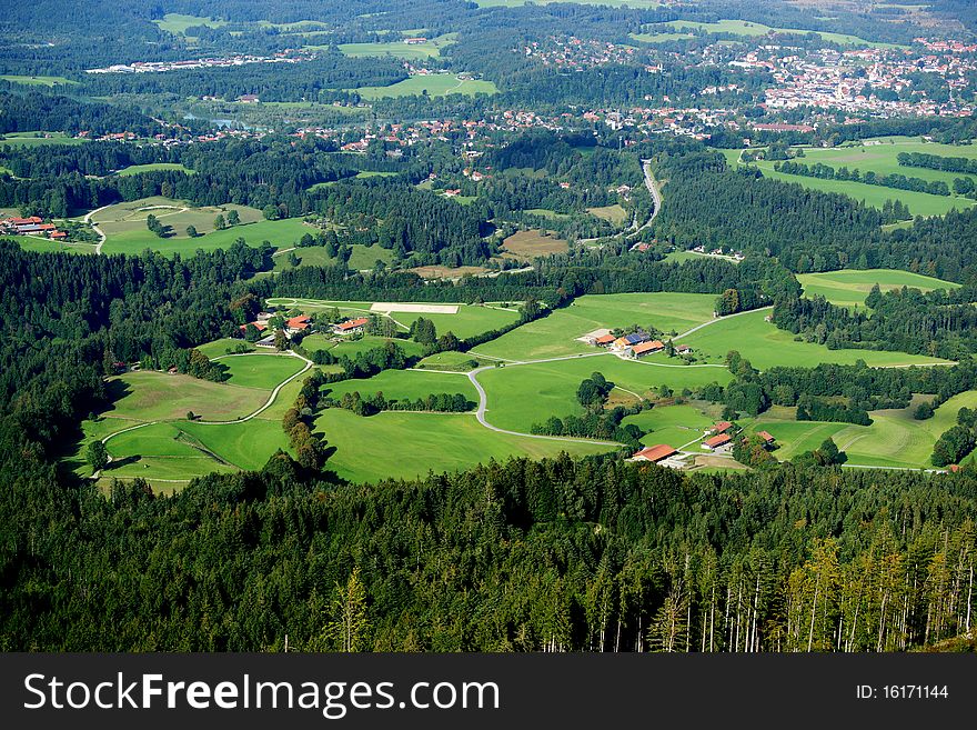 An aerial view of a Bavarian landscape with the town of Bad Toelz in the distance.
