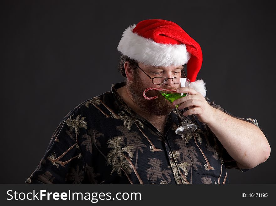 An obese man in Santa hat and tropical shirt